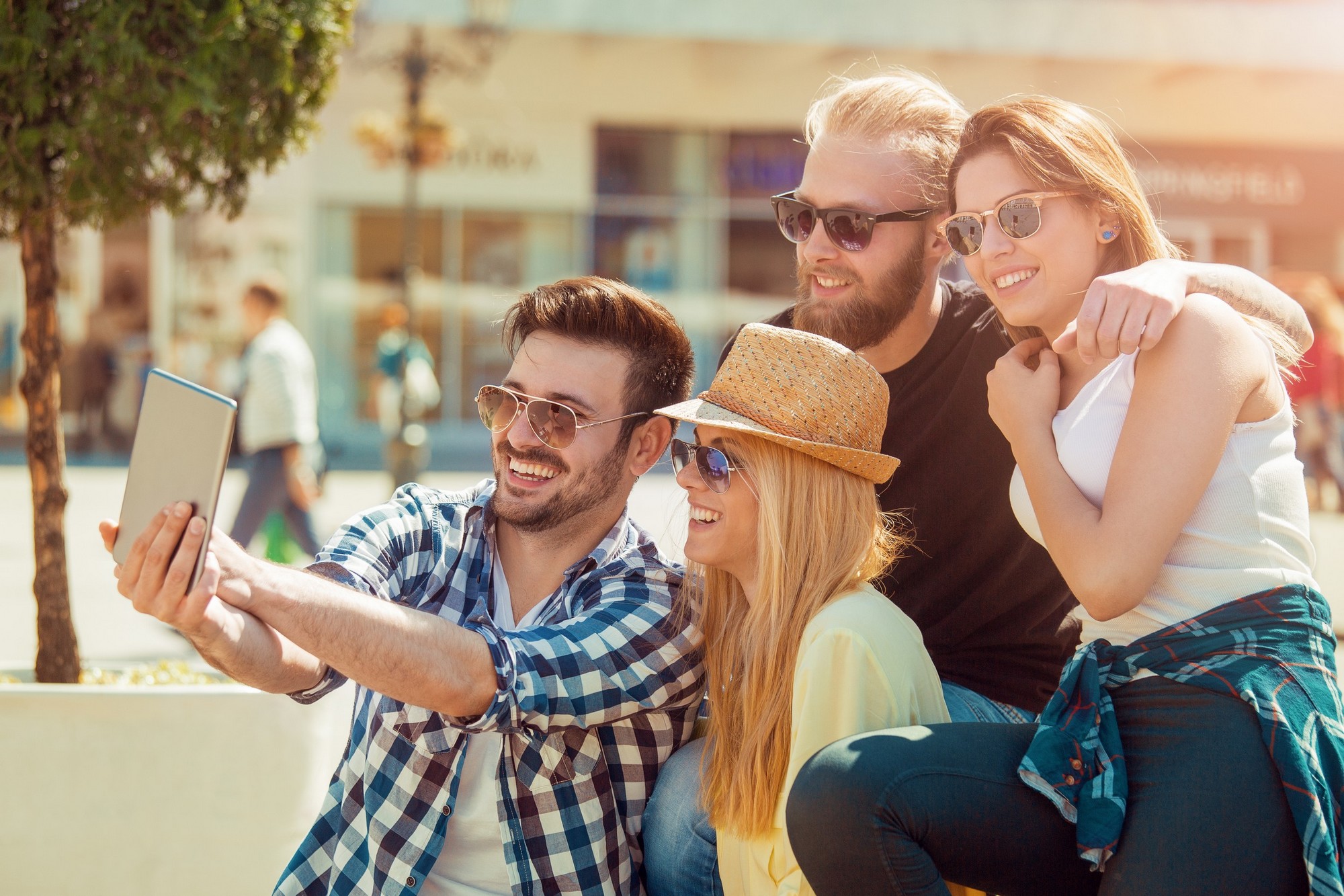 Group of friends taking a selfie with smartphone.