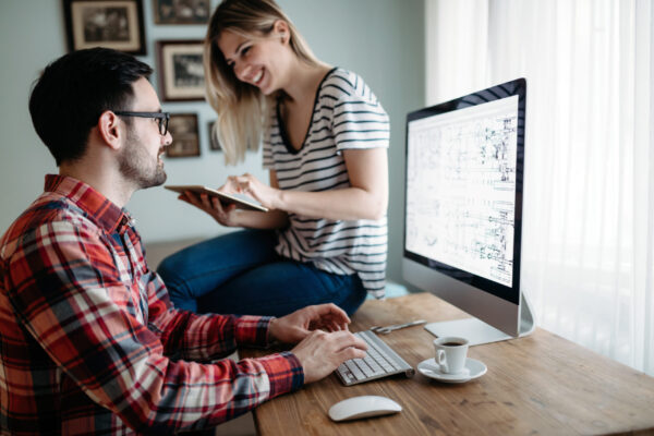 Young attractive designers working on project together